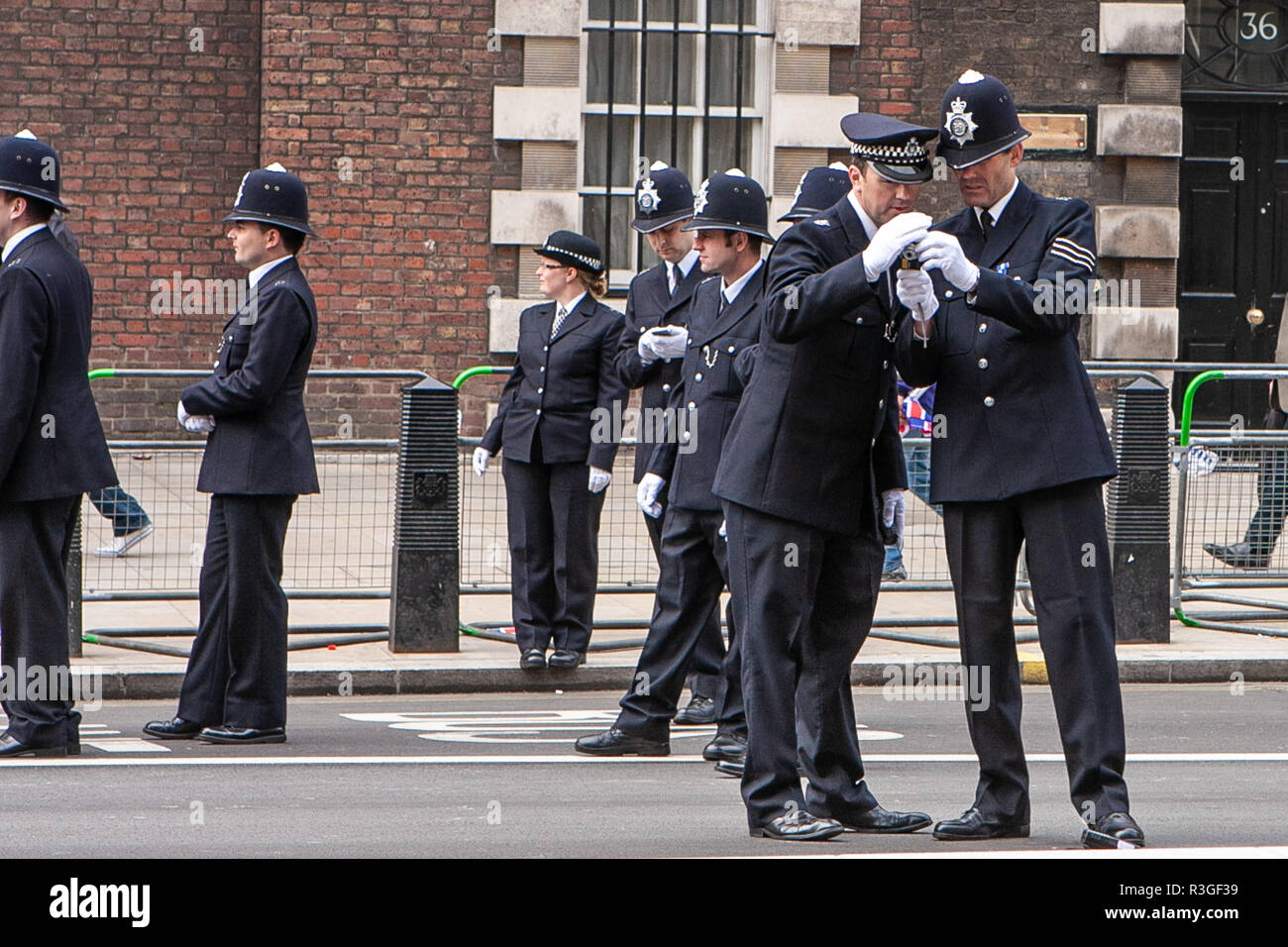 Police officers checking a photo taken on a mobile phone Stock Photo