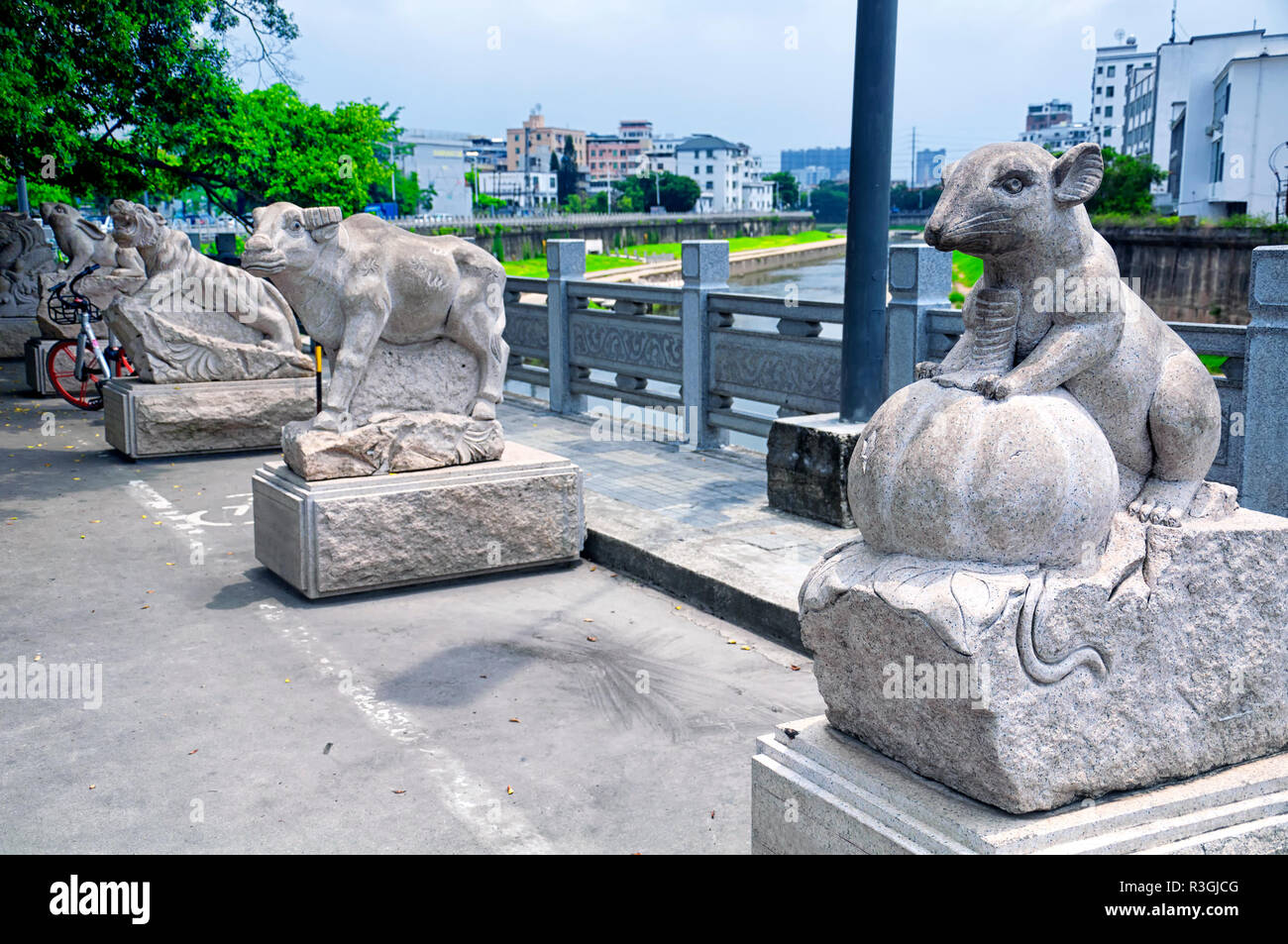 Chinese zodiac animal statues along a water canal in the longhua
