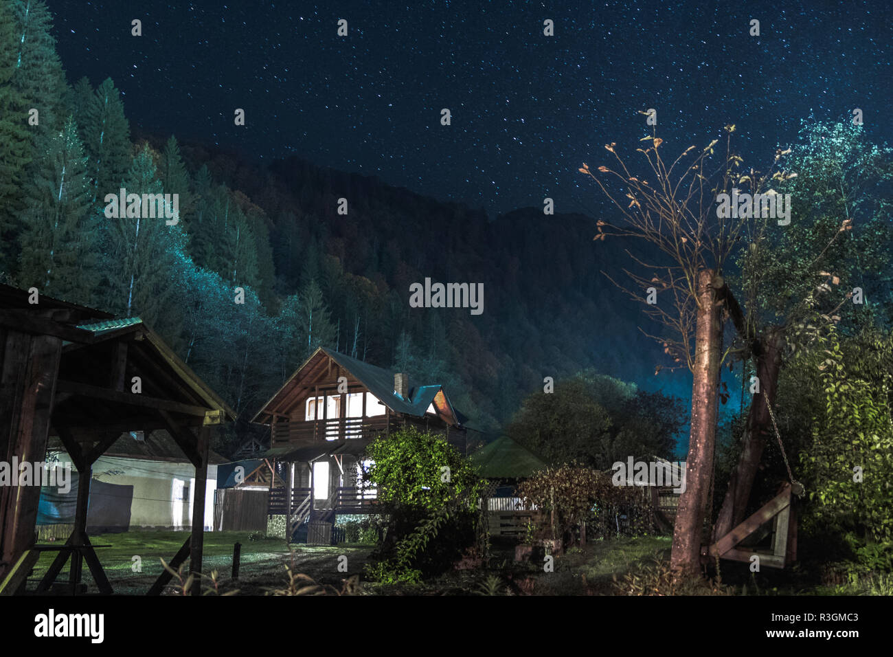 Wooden house at night and stars Stock Photo