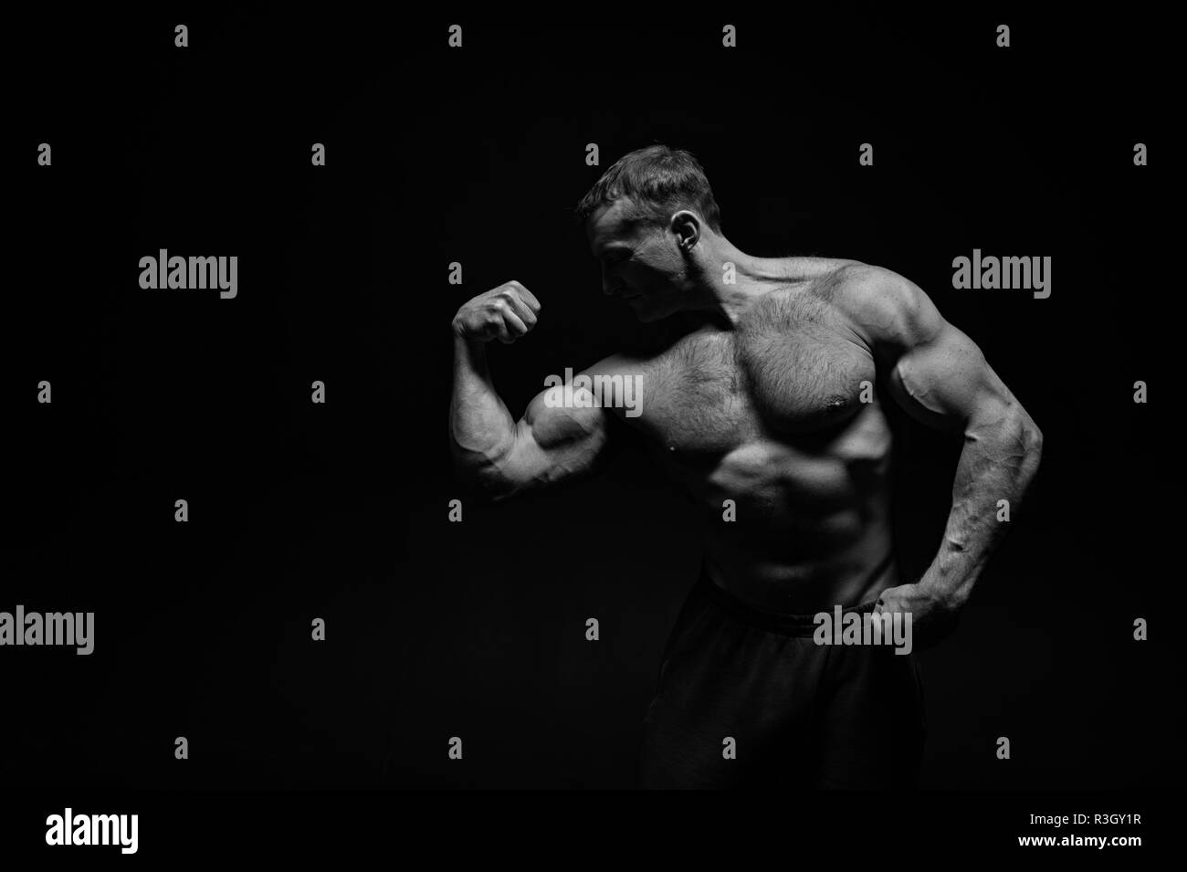 Muscle concept. Muscle man flex biceps and triceps. Bodybuilder with strong  muscle body. Muscle building exercise, black and white Stock Photo - Alamy