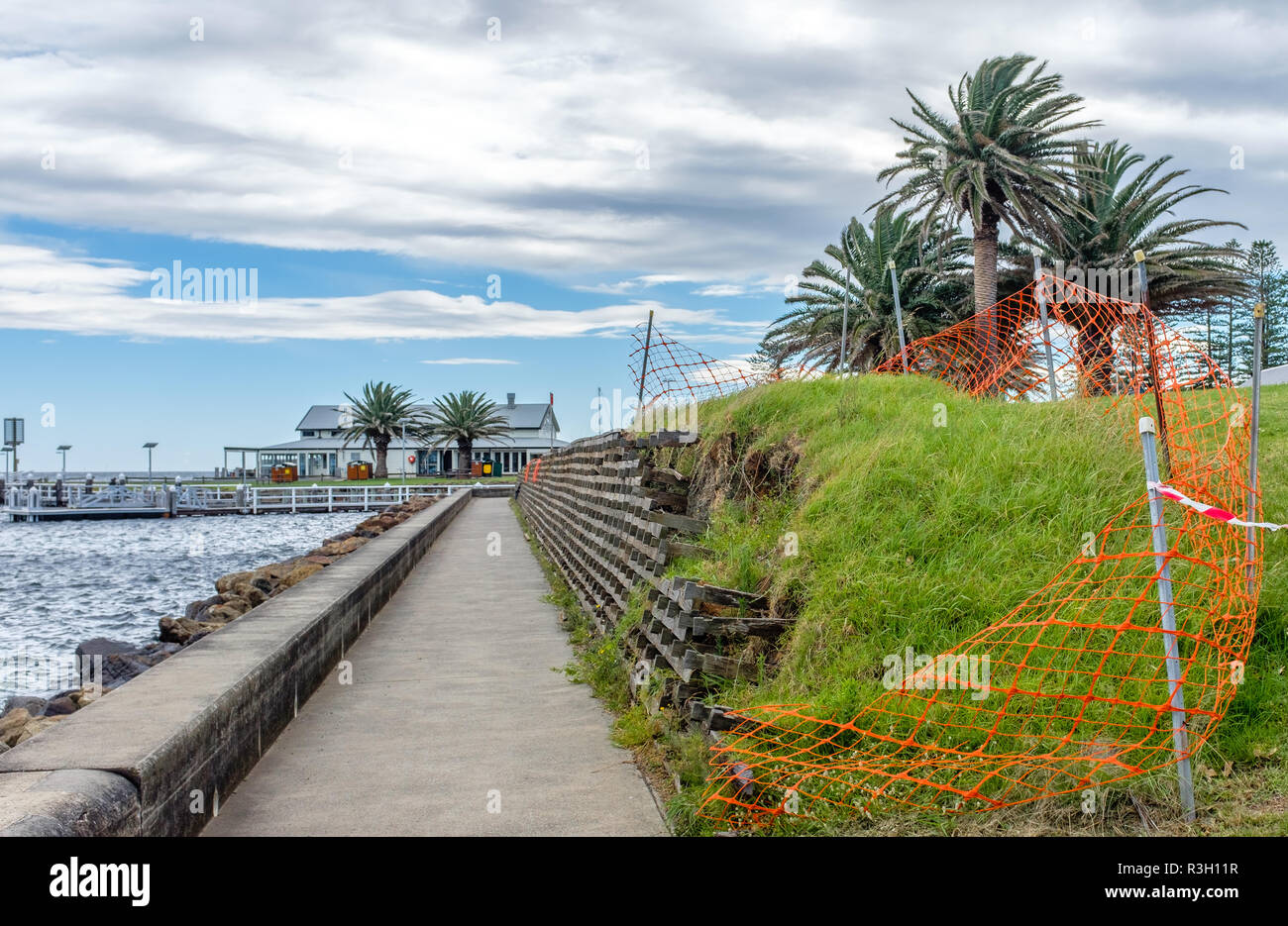 climate change erosion damage to harbour wall reinforcements caused by storm damage after extreme weather event to harbour wall, NSW, Australia Stock Photo