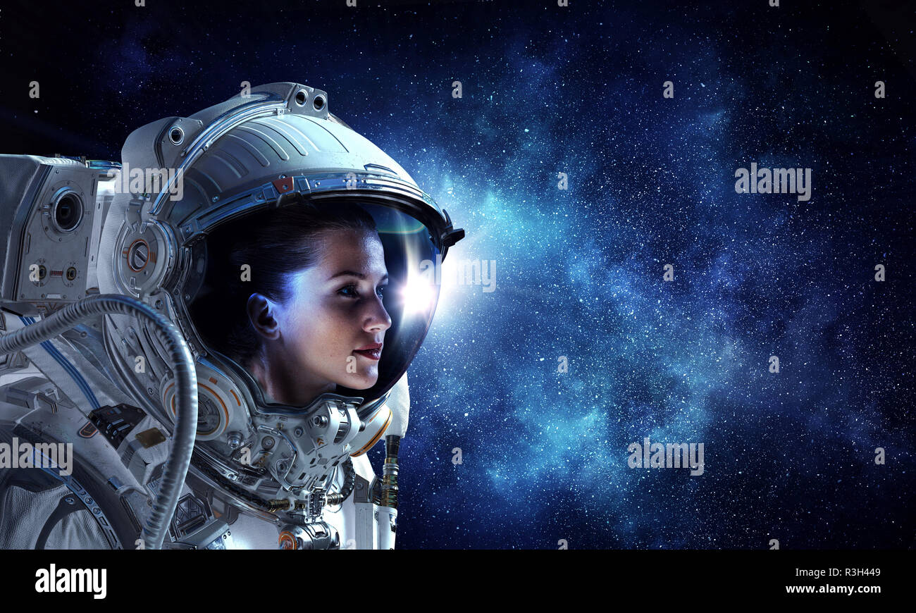 Attractive woman in spacesuit Stock Photo