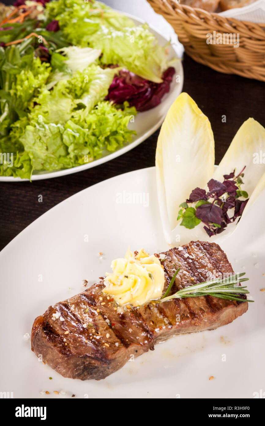 juicy grilled sirloin steak with homemade herb butter Stock Photo