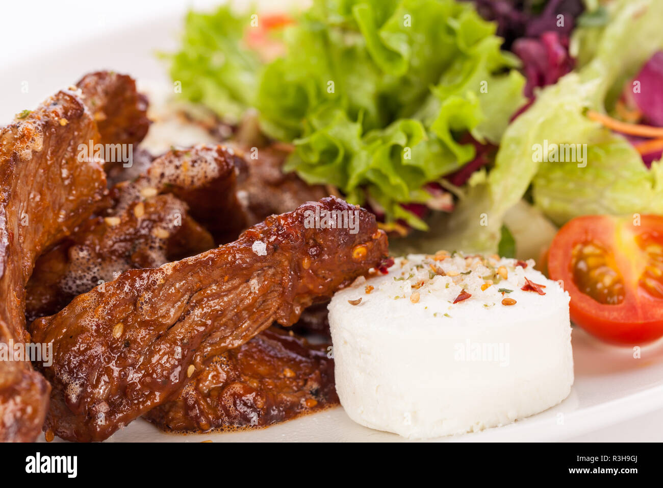 fresh salad with goat cheese and fried beef strips Stock Photo