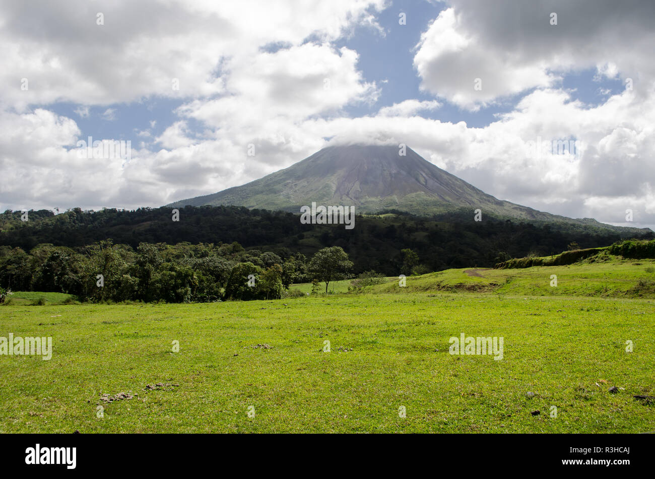 Arenal Volcano as seen from La Fortuna in Costa Rica, during a cloudy day. Stock Photo