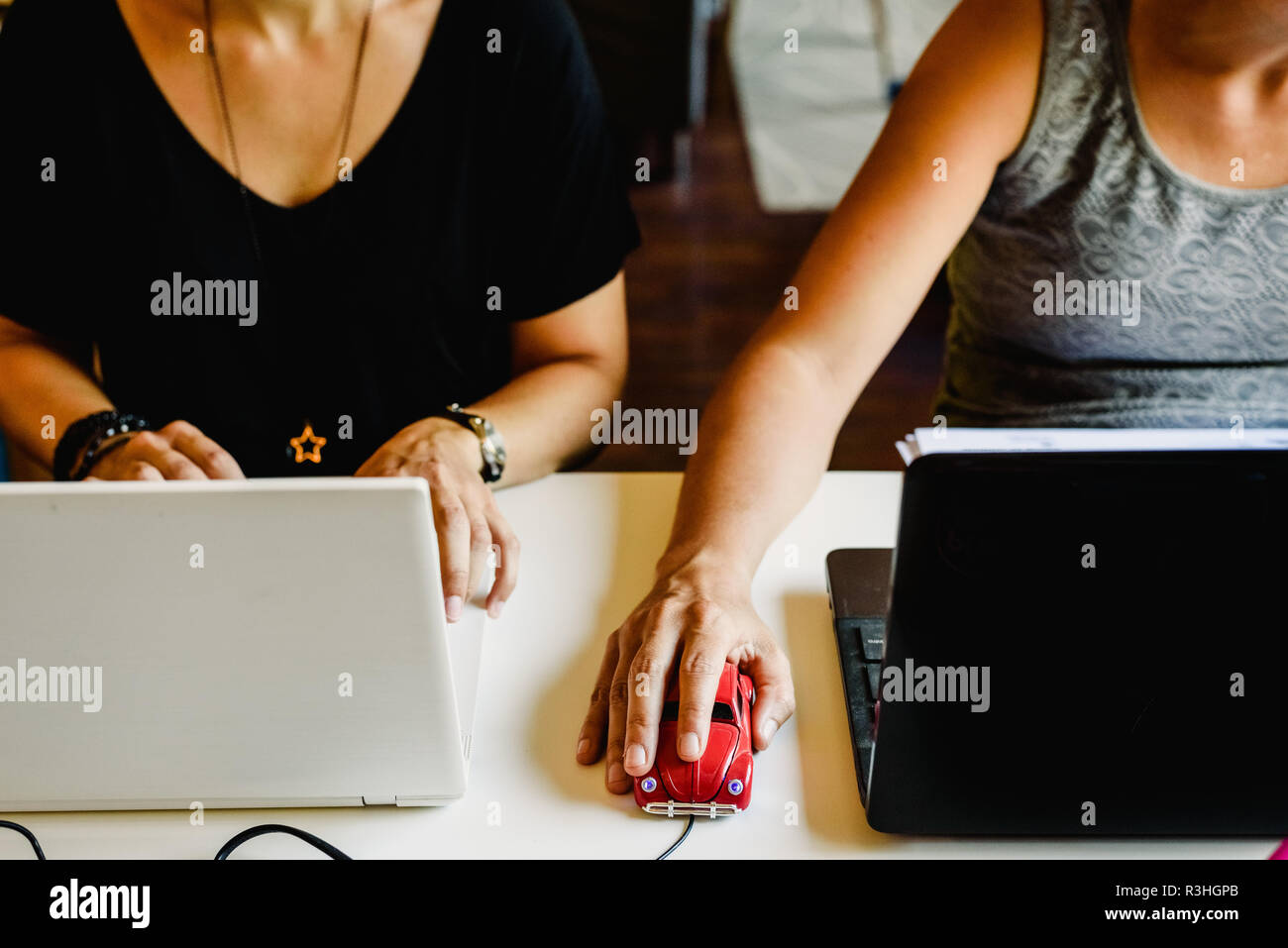 Two women working on their office computers in a school Stock Photo - Alamy