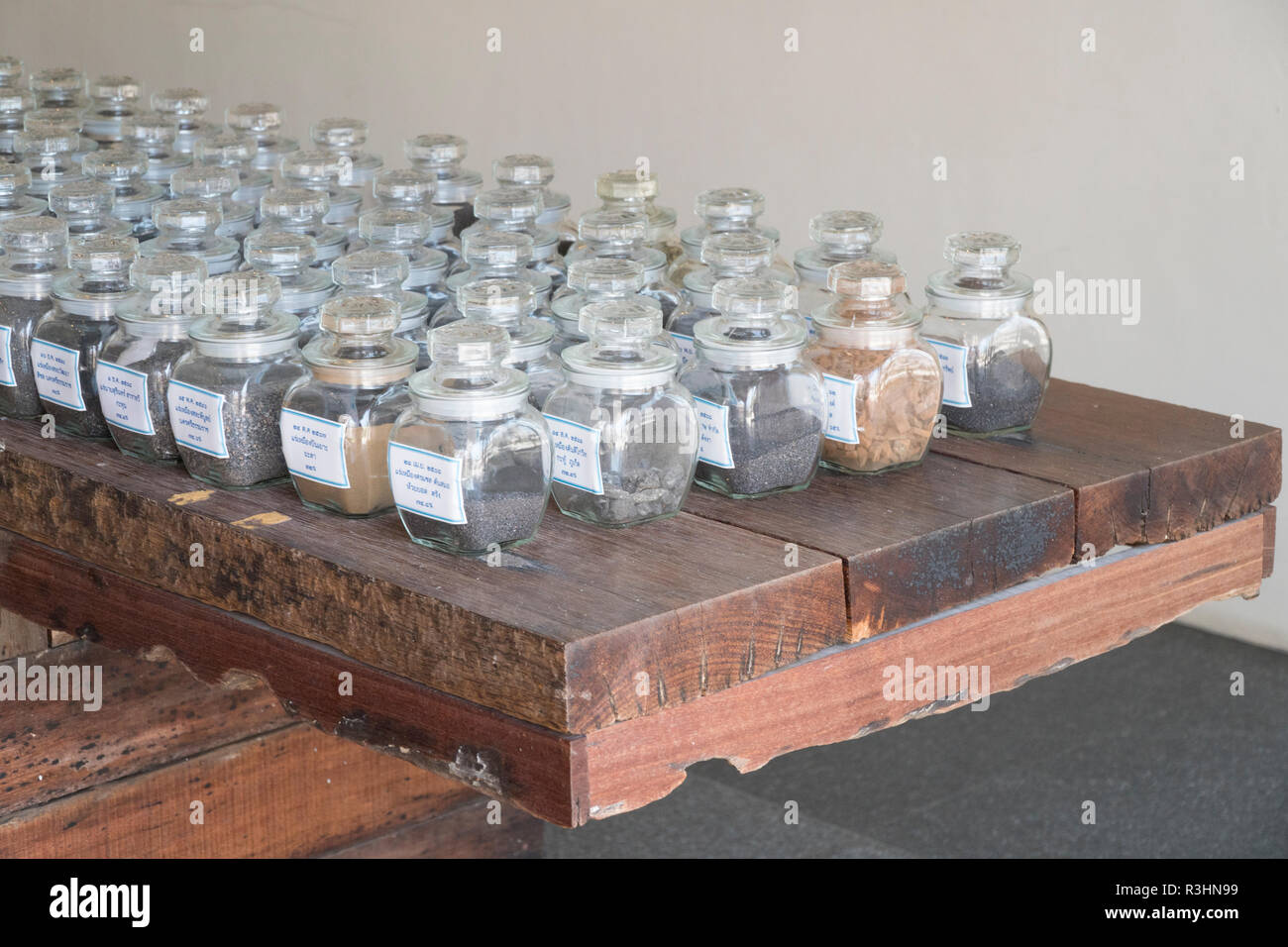 Collage of rocks and minerals, semiprecious stones in the glass jars Stock Photo