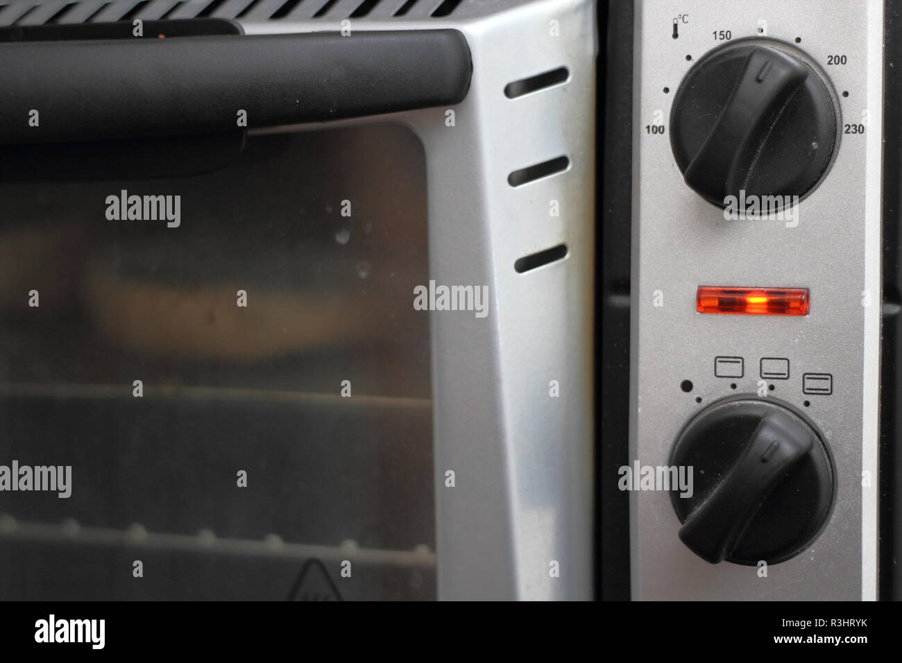 Toasting bread rolls in electric oven Stock Photo Alamy