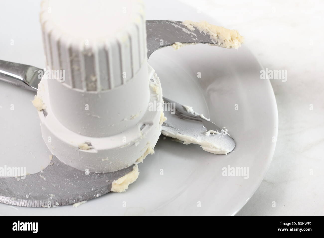 Dirty blades of blender and table knife on plate. Making Treacle Pie Series  Stock Photo - Alamy