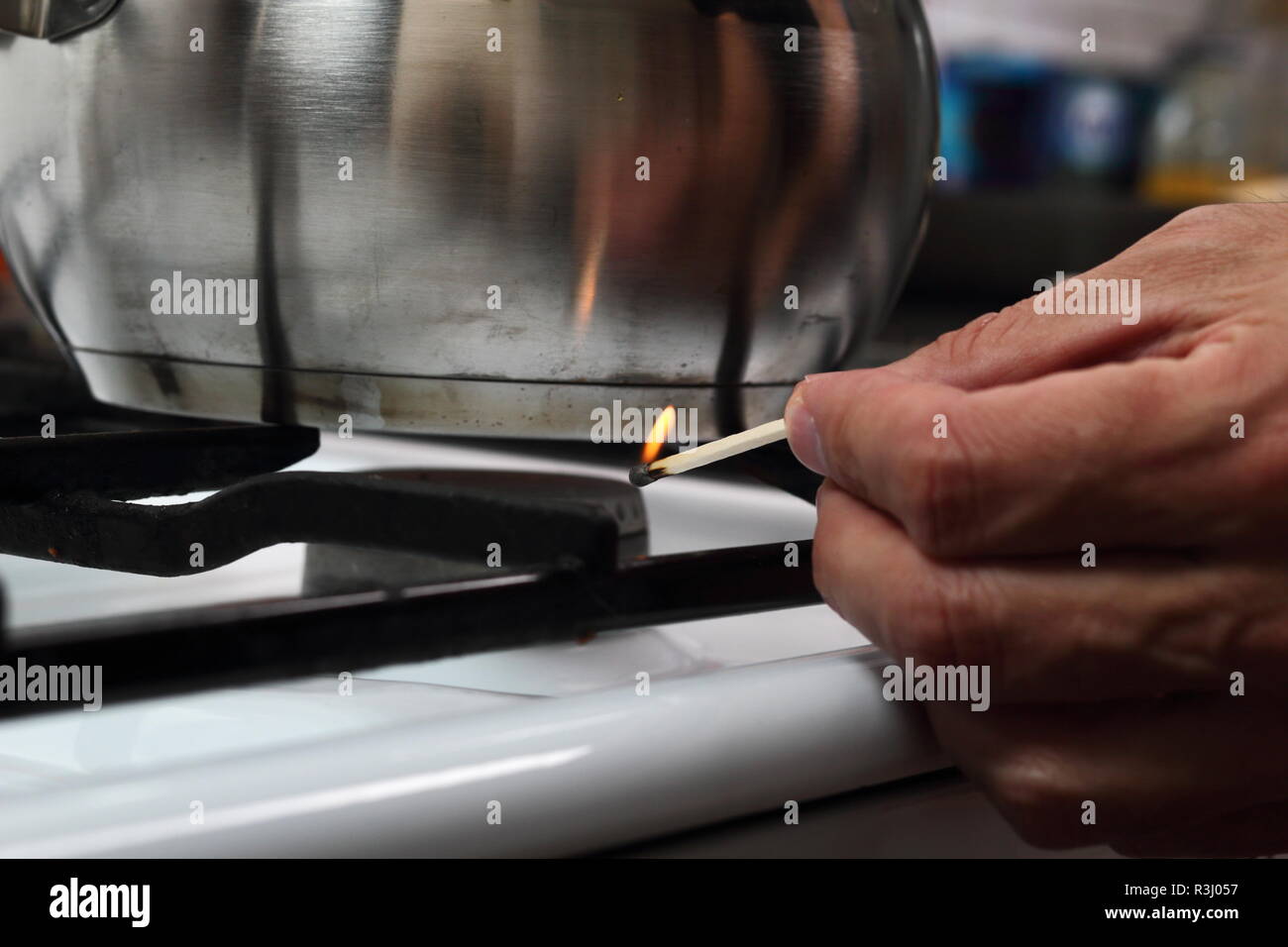Light gas stove with match Stock Photo Alamy