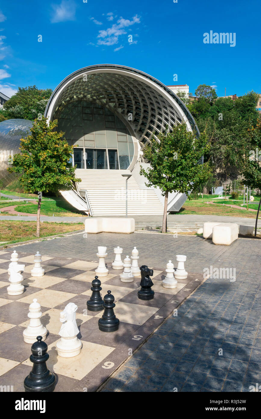 Giant chess game in front of the Concert Hall and Exhibition Centre, Rike Park, Tbilisi, Georgia Stock Photo