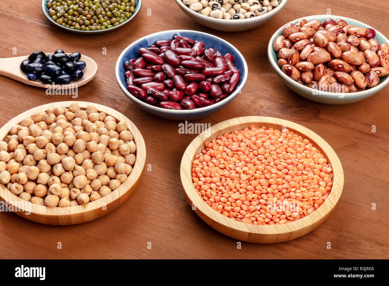 Various legumes on a dark rustic wooden background. Red kidney beans