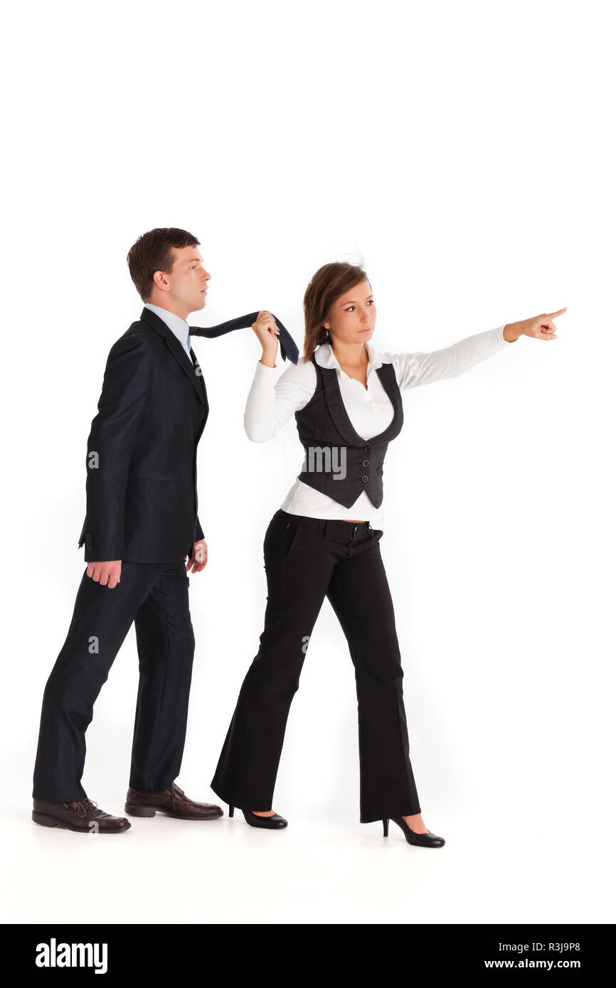 woman pulling a man in a suit Stock Photo