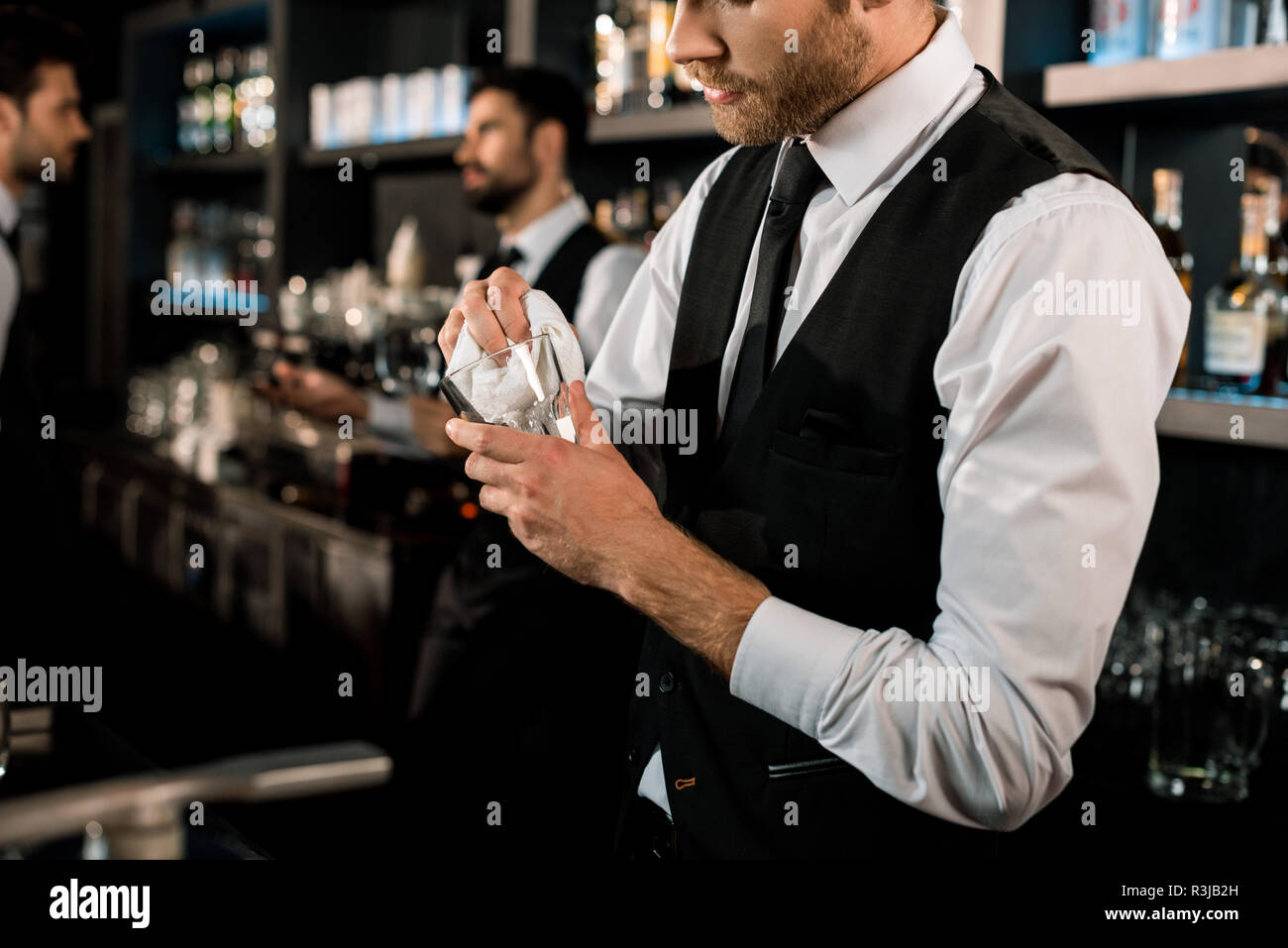 Bartender Standing at Bar Counter, Cleaning Glasses with Towel Stock Photo  - Image of portrait, informal: 190411966