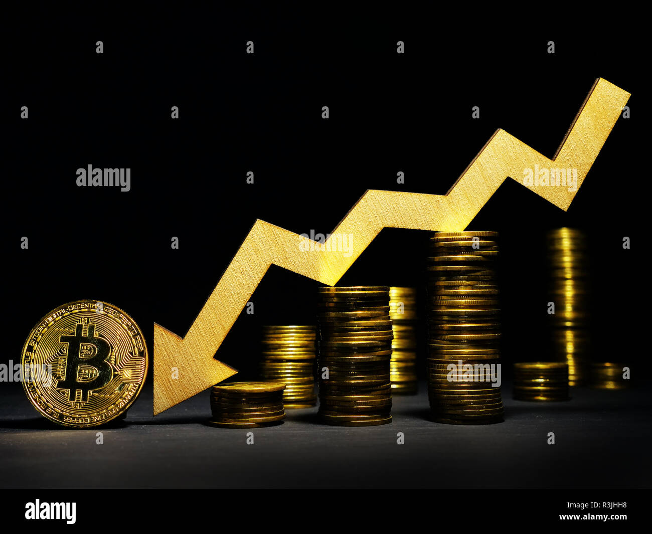 Fall of Bitcoin btc cost. Down arrow and coins. Stock Photo