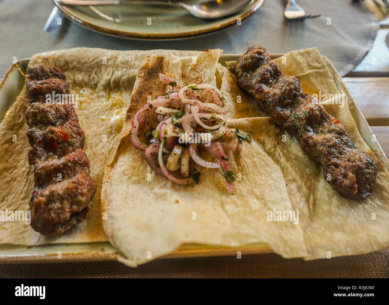 Armenian Simple Meat Kabab and Onions on Bread with Onions Stock Photo