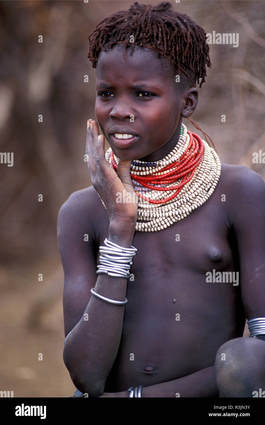 Africa, Ethiopia, Omo region. A young woman with typical Bume tribe neck adornment. (MR) Stock Photo