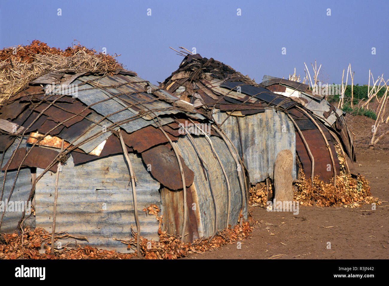 Africa, Ethiopia, Omo region. Galeb tribe houses made of grass, cloth and sheets of tin. Stock Photo