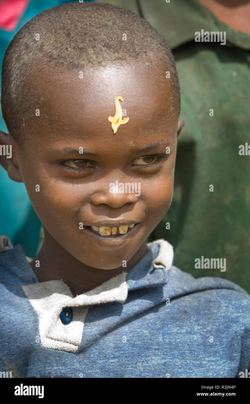 Africa, Ethiopia, Omo region. Young smiling boy with a sticker on his forehead in the Konso tribe village of Busso. Stock Photo
