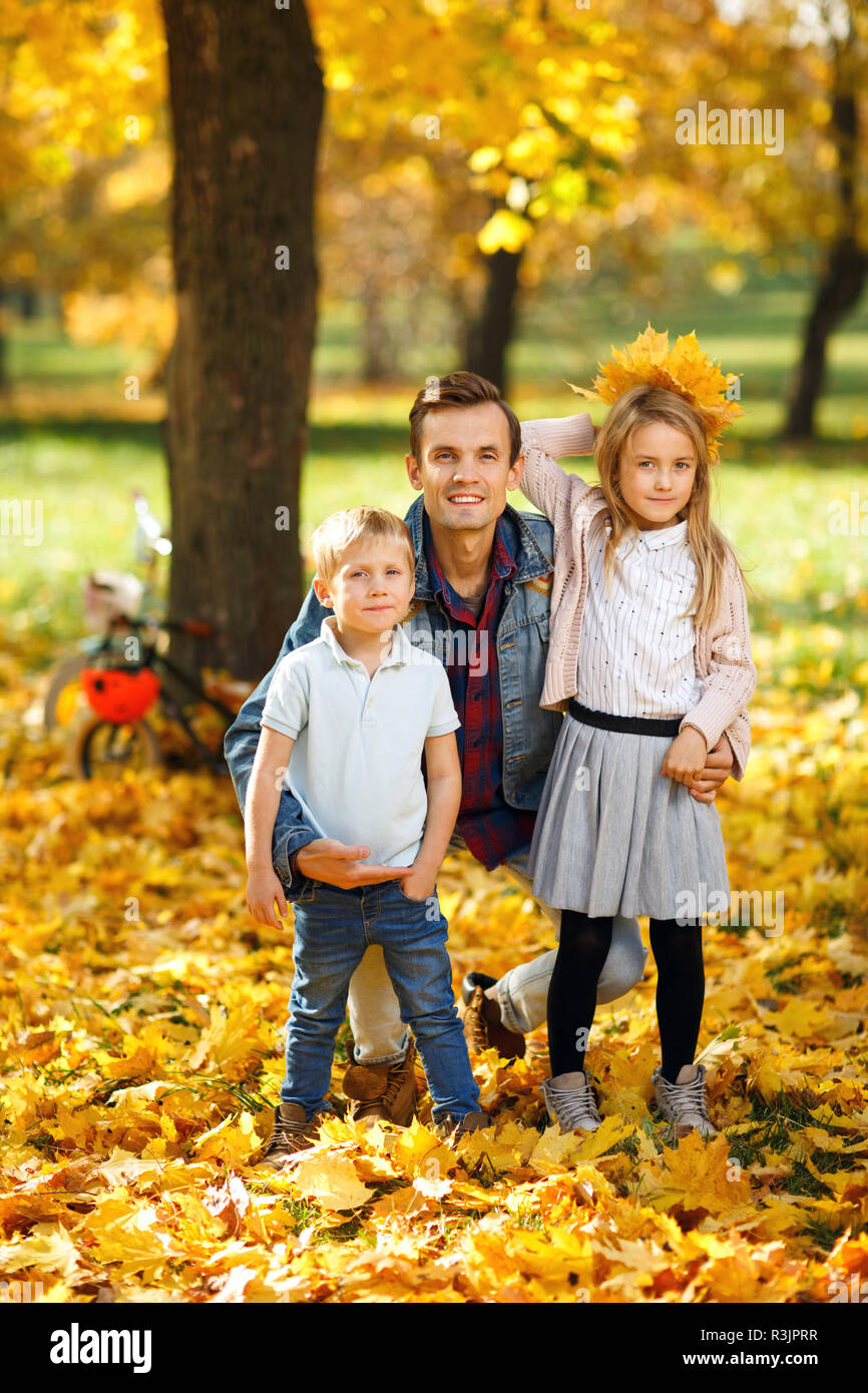 Image of father with daughter and son in autumn park walking Stock ...