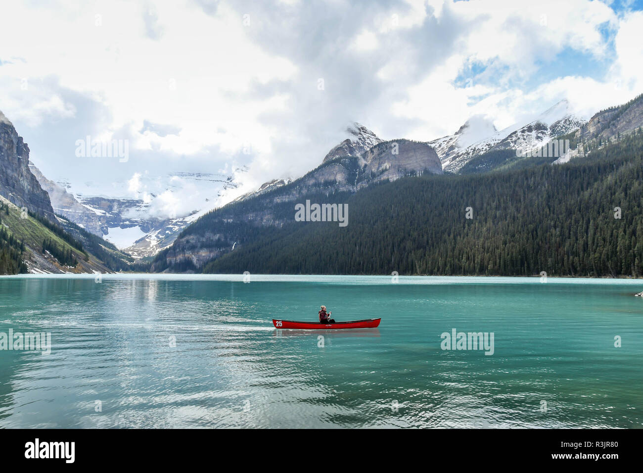 LAKE LOUISE, AB, CANADA - JUNE 2018: Person paddling a canoe on Lake Louise in Alberta, Canada. Stock Photo