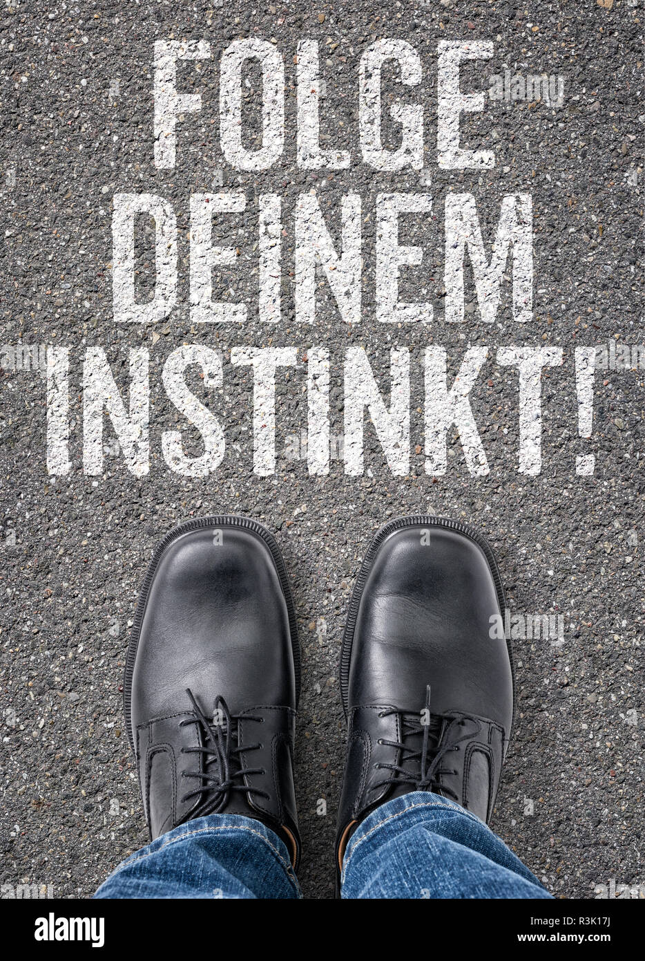 text on the ground - follow your instinct Stock Photo