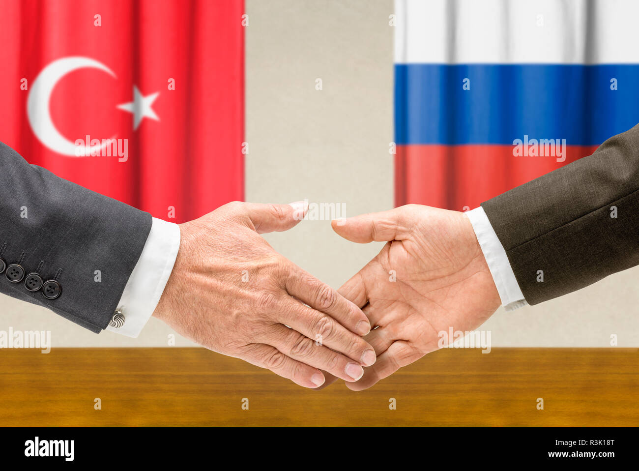 representatives of turkey and russia reach their hand Stock Photo