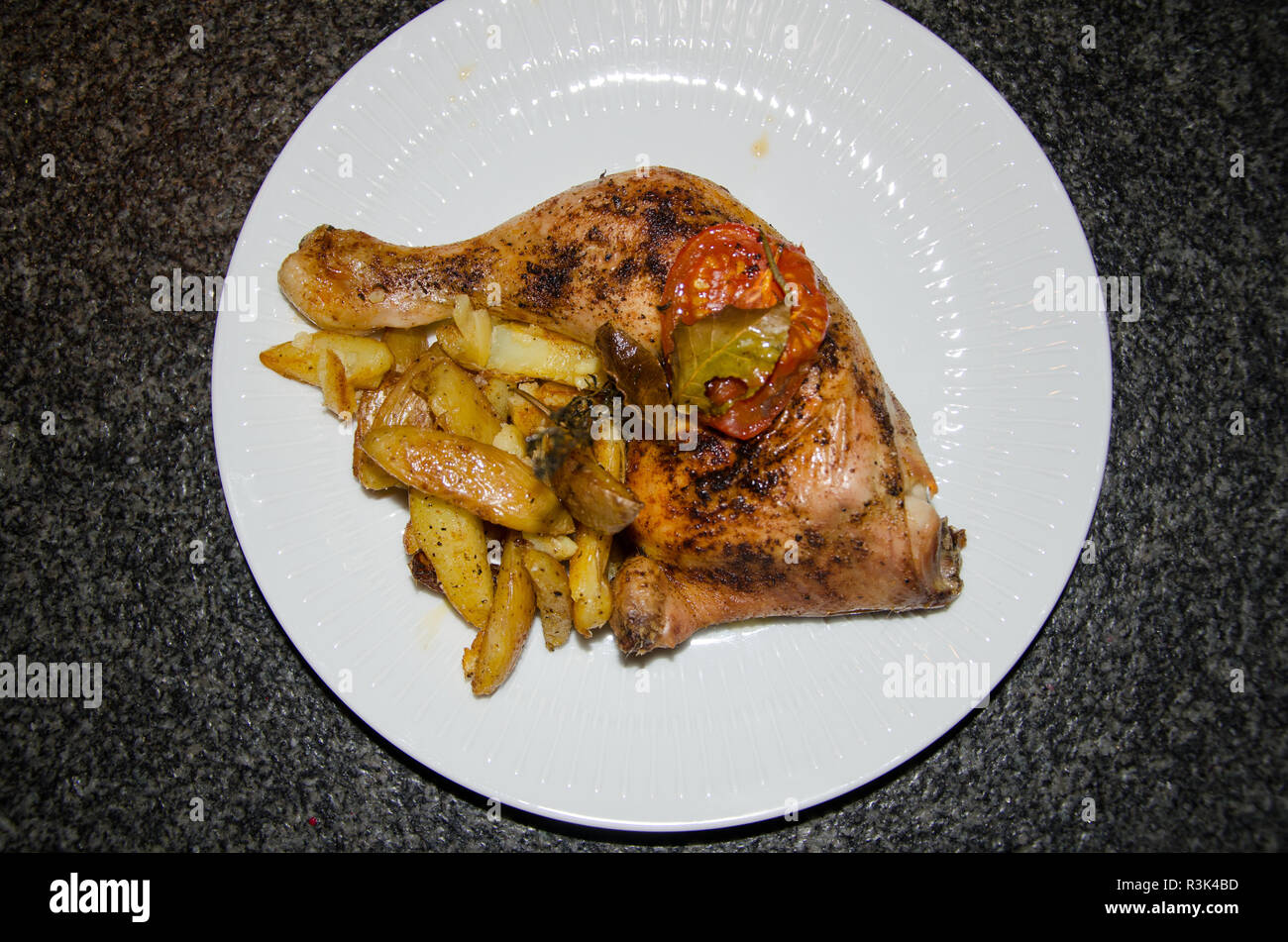 chicken thighs with potato wedges Stock Photo Alamy