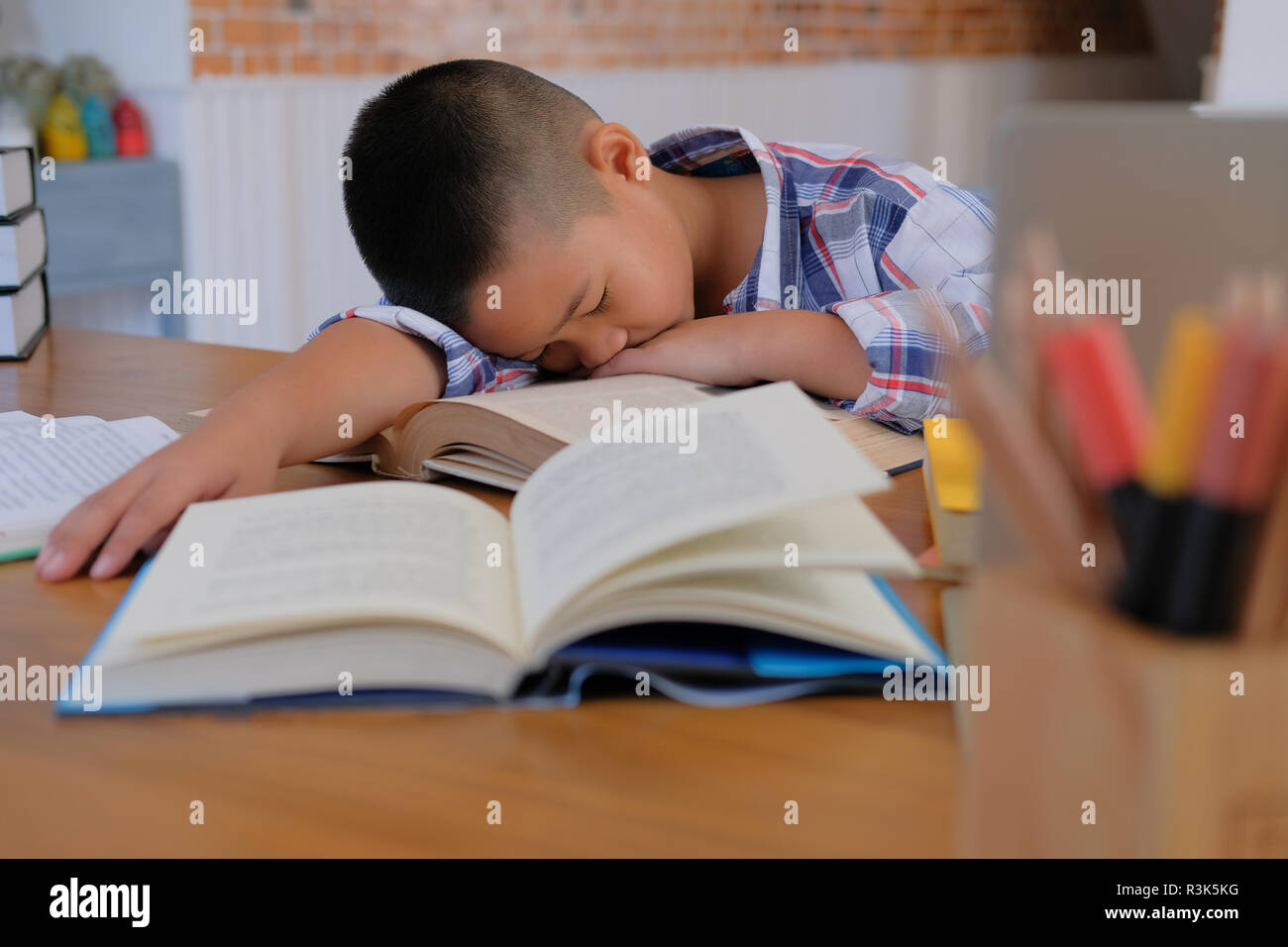 Lazy Stressed Young Little Asian Kid Boy Resting Sleeping On Desk