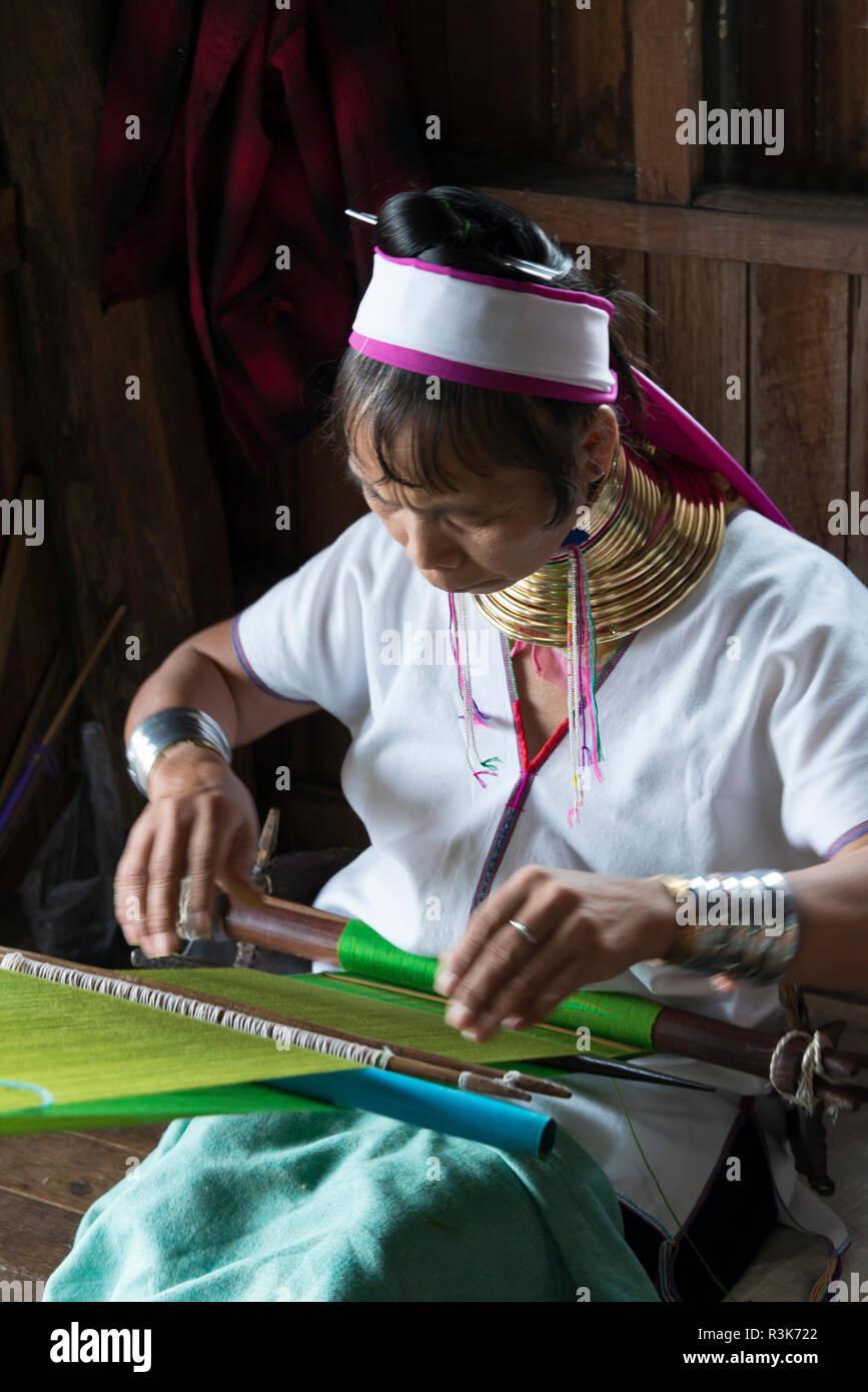 Padaung (Kayan Lahwi) woman wearing brass neck coils weaving, Inle Lake, Shan State, Myanmar Stock Photo