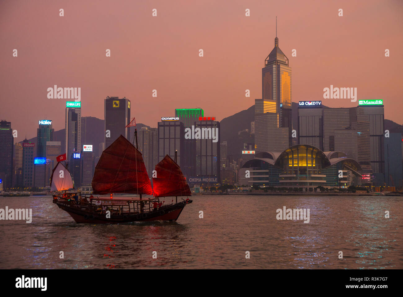 China, Hong Kong. Boat in harbor and skyline. Credit as: Jim Zuckerman / Jaynes Gallery / DanitaDelimont.com Stock Photo