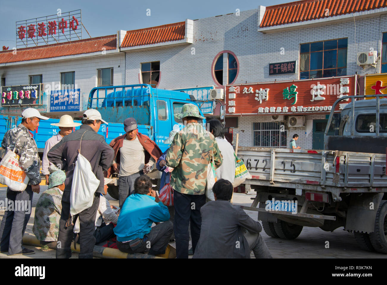 China, Xinjiang, Workers gambling in a remote town named 121. Stock Photo