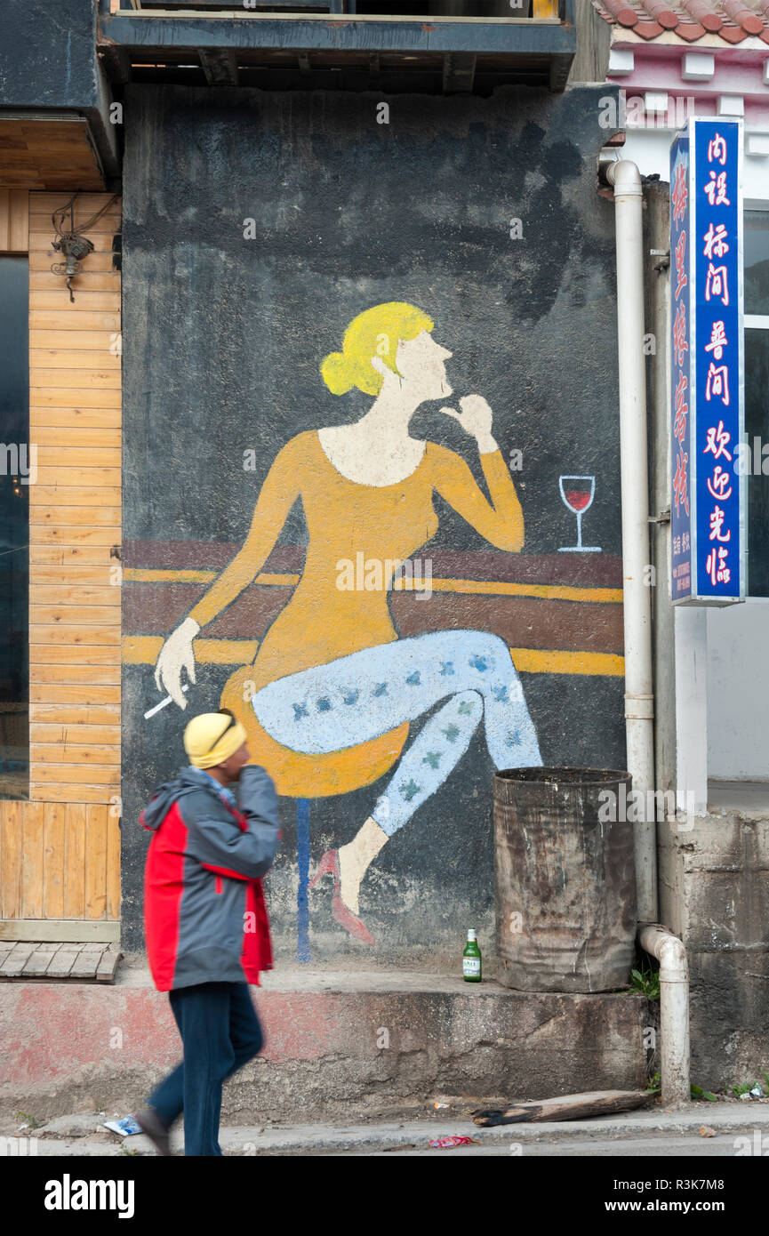 Billboard-like mural outside a restaurant in Sheng Ping town in northwest Yunnan Province, China. Stock Photo
