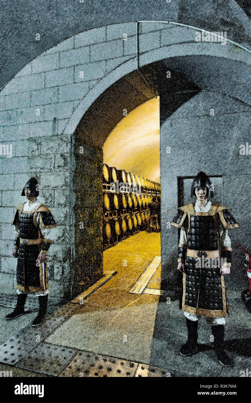 Two guards in ancient costume stand outside cellar during Yantai Wine Festival at Changyu winery in the Shandong Province, China. Stock Photo