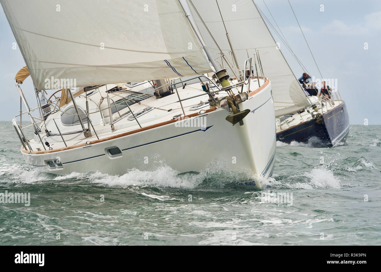 Two beautiful white yachts, sailboats or sail boats sailing or racing at sea Stock Photo
