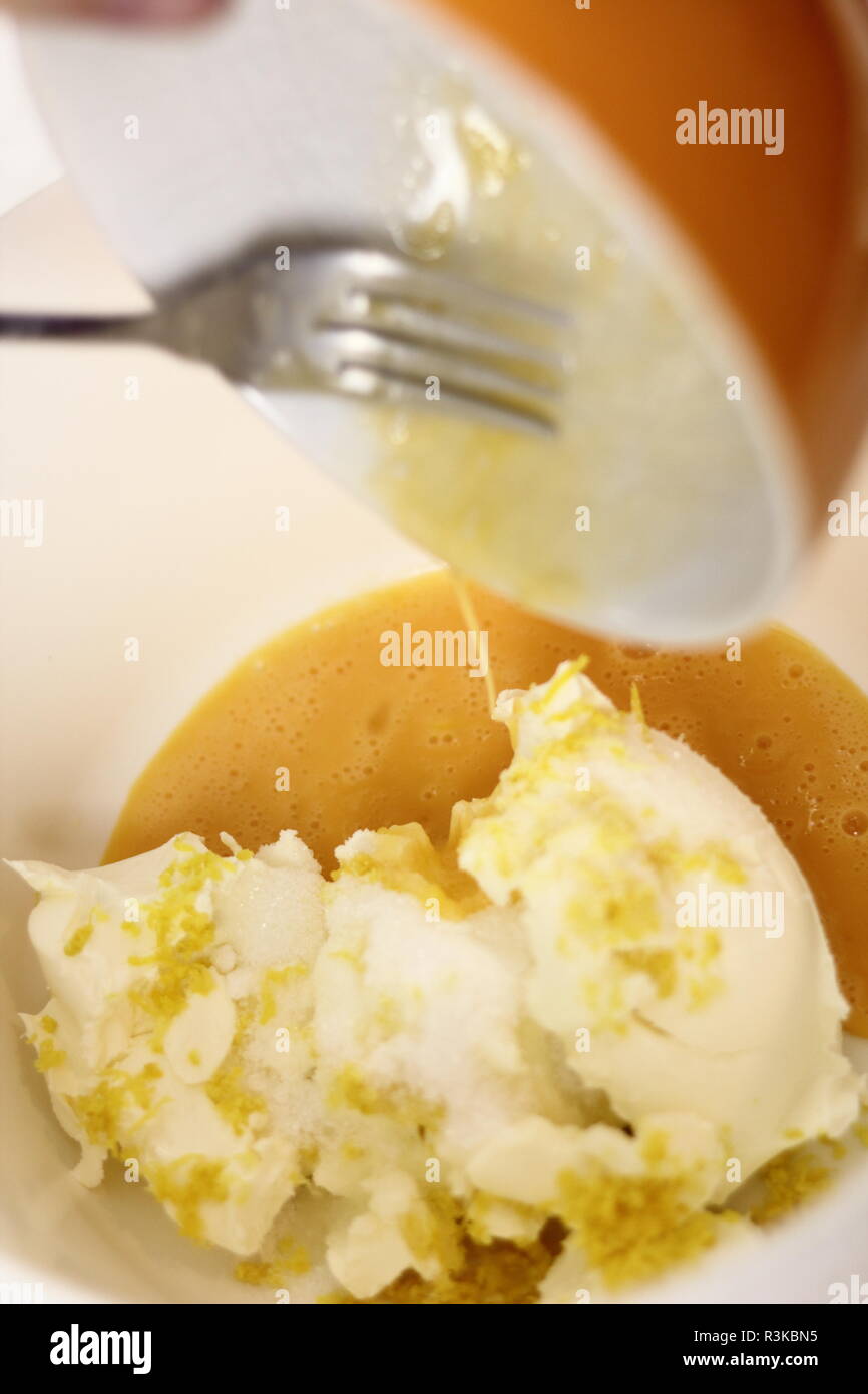 Add beaten egg into cream cheese with lemon rind and sugar. Making