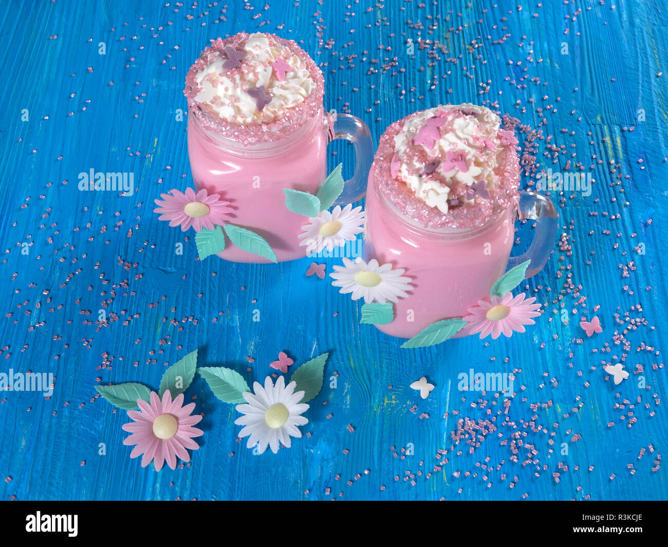Pink unicorn milk shake with whipped cream, sugar and sprinkles Stock Photo