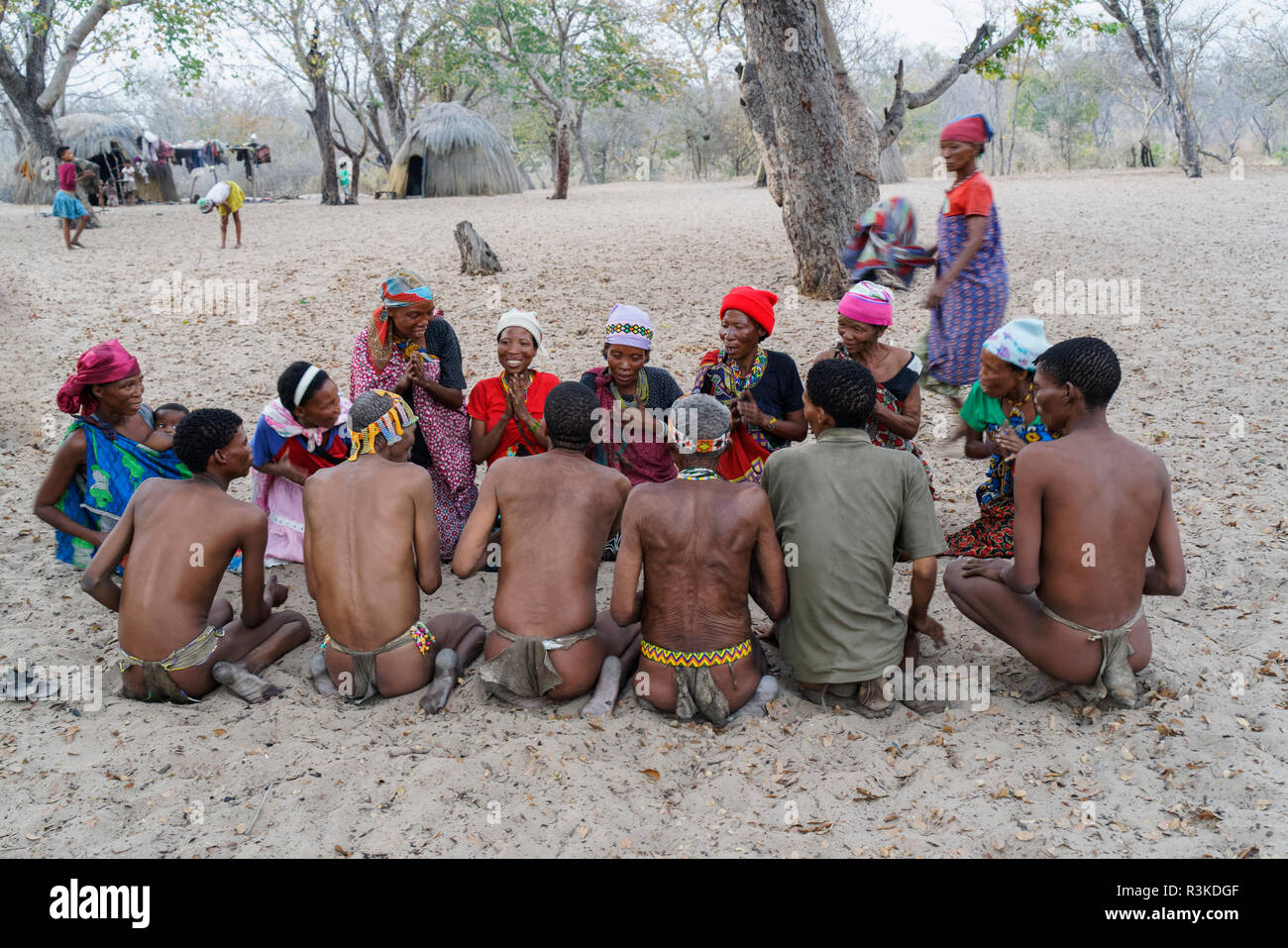 Men and women playing a game in the San Bushmen village near Nhoma ...