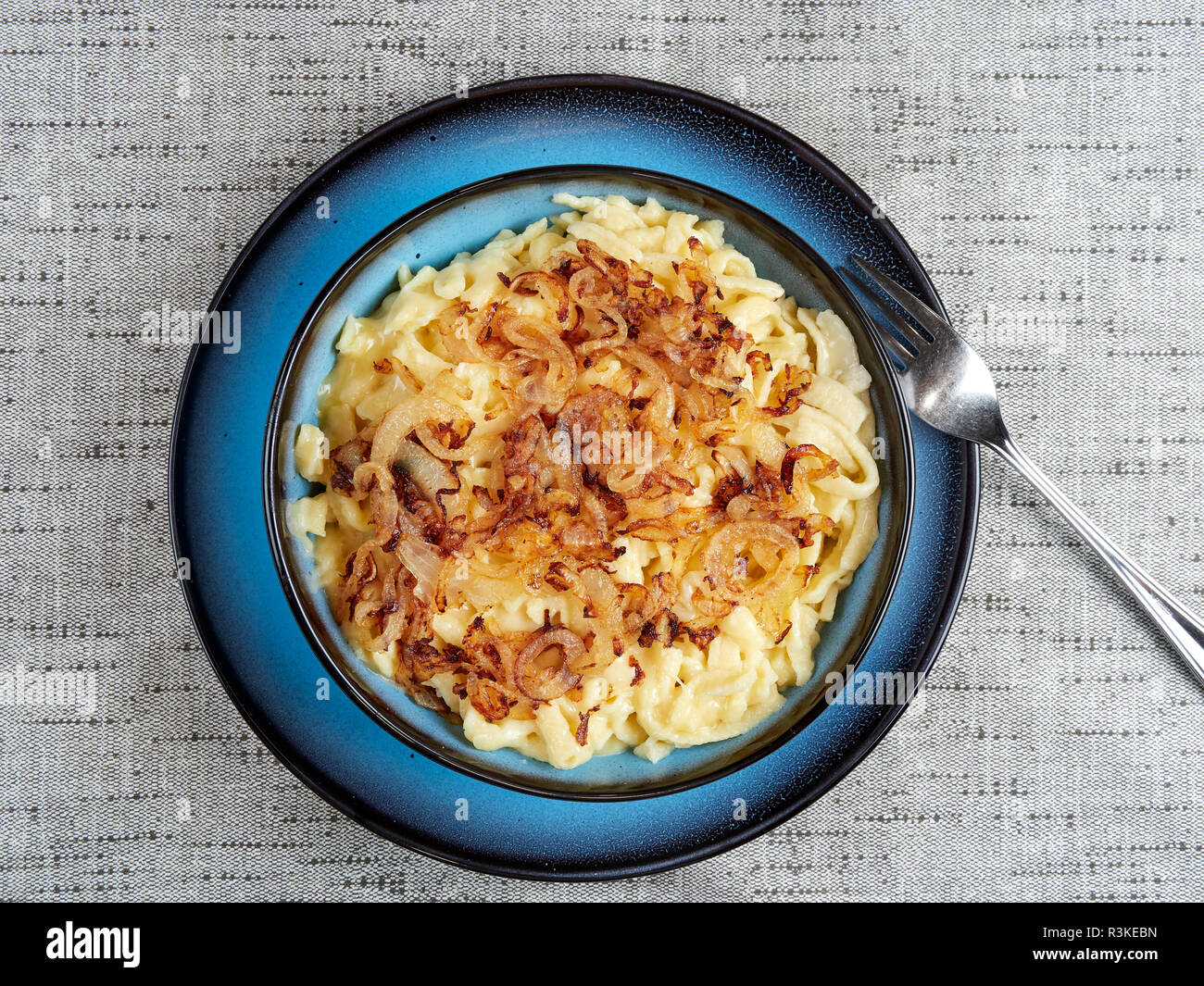 Traditional Swabian "Käsespätzle" - a dish of egg and flour noodles with grated cheese and fried onions. Also spelled kaesespaetzle Stock Photo