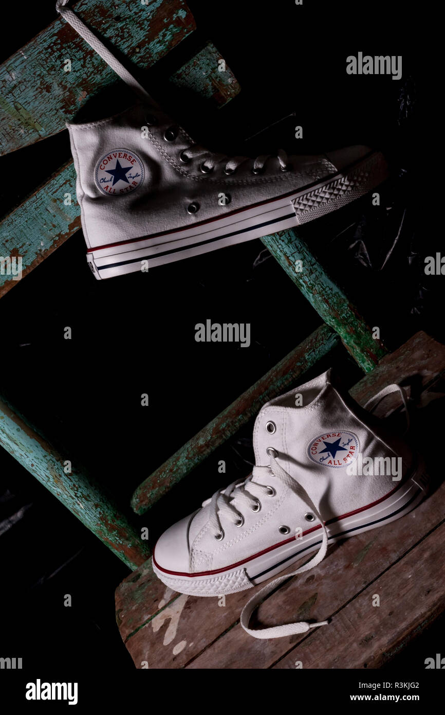 ESKISEHIR, TURKEY - MAY 9, 2010: White Converse sneakers on an old green  chair background Stock Photo - Alamy