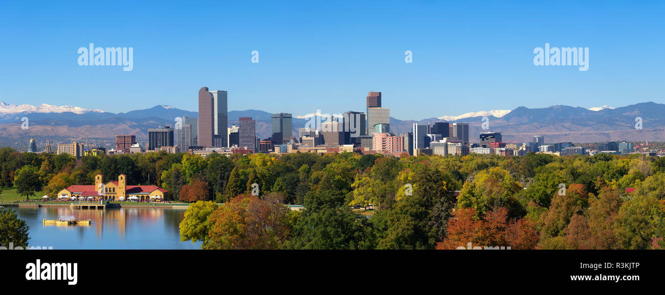 City skyline of Denver Colorado downtown with snowy Rocky Mountains and the City Park Lake. Large panorama. Stock Photo