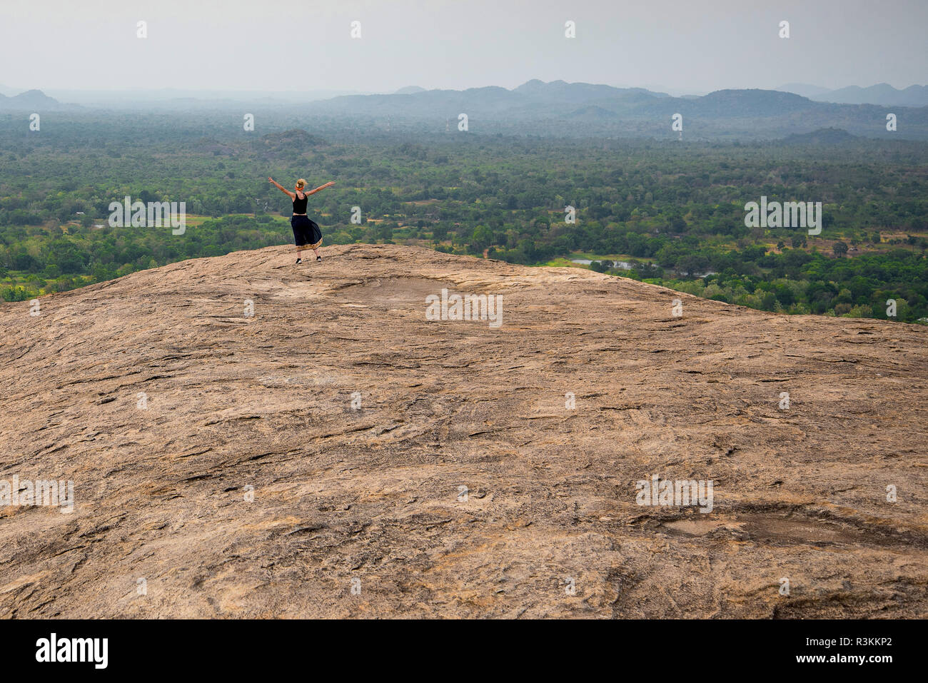 A person viewing the Lion Rock in Sigiriya from Pidurangala, Sri Lanka Stock Photo