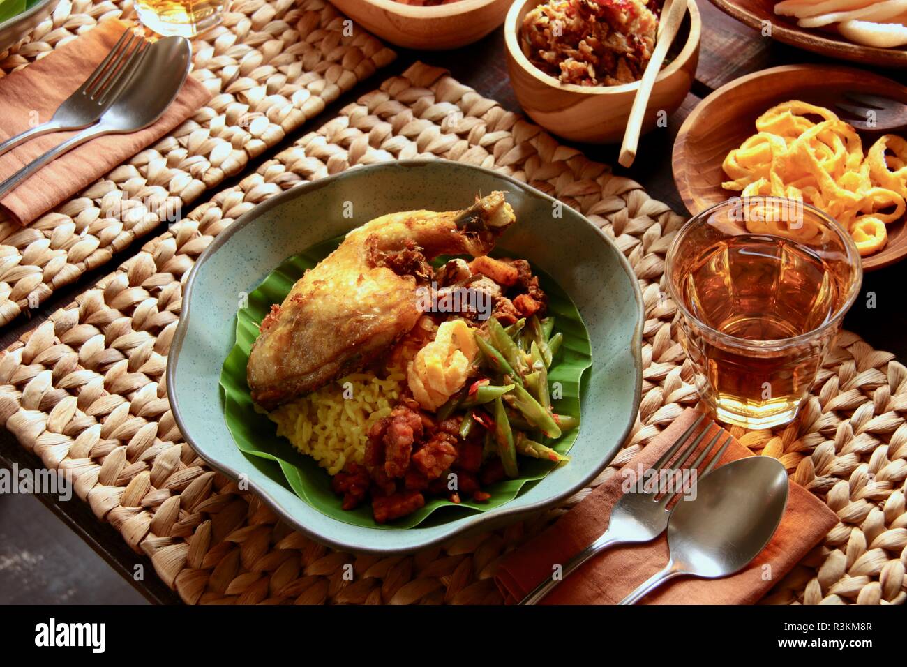 Nasi Kuning. Traditional Indonesian yellow (turmeric) rice, accompanied ...