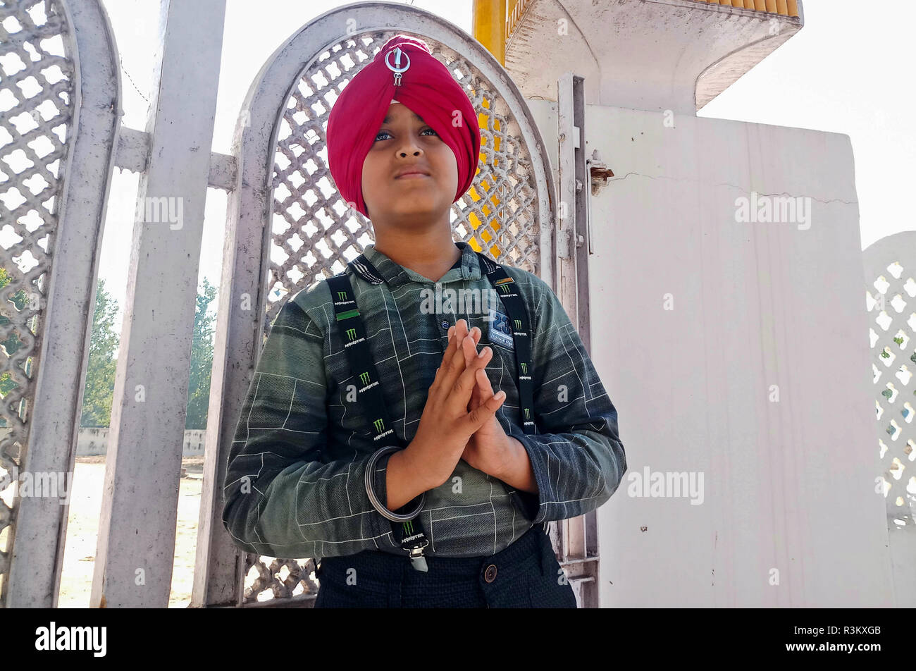 A Sikh devotee seen praying outside Gurdwara or a Sikh temple during the occasion of the 550th birth anniversary of Guru Nanak Dev, in Mohali. Sikhism was founded in the 15th century by Guru Nanak, who broke away from Hinduism, India’s dominant religion, He preached the equality of races and genders and the rejection of image-worship and the caste system. Stock Photo