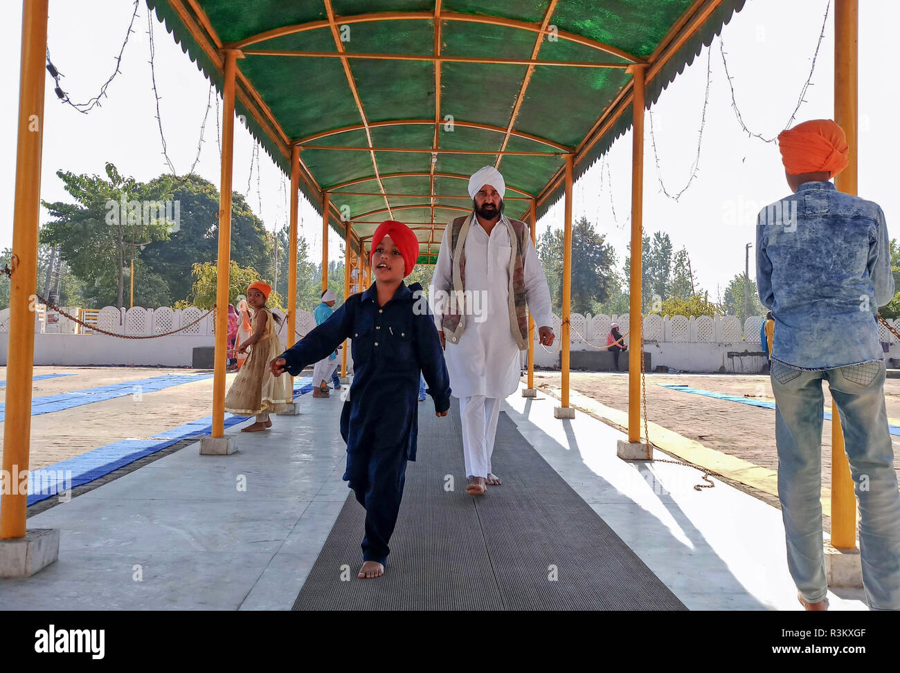 Devotees are seen paying obeisance at the Khanpur Gurduwara during the occasion of the 550th birth anniversary of Guru Nanak Dev in Mohali. Sikhism was founded in the 15th century by Guru Nanak, who broke away from Hinduism, India’s dominant religion, He preached the equality of races and genders and the rejection of image-worship and the caste system. Stock Photo