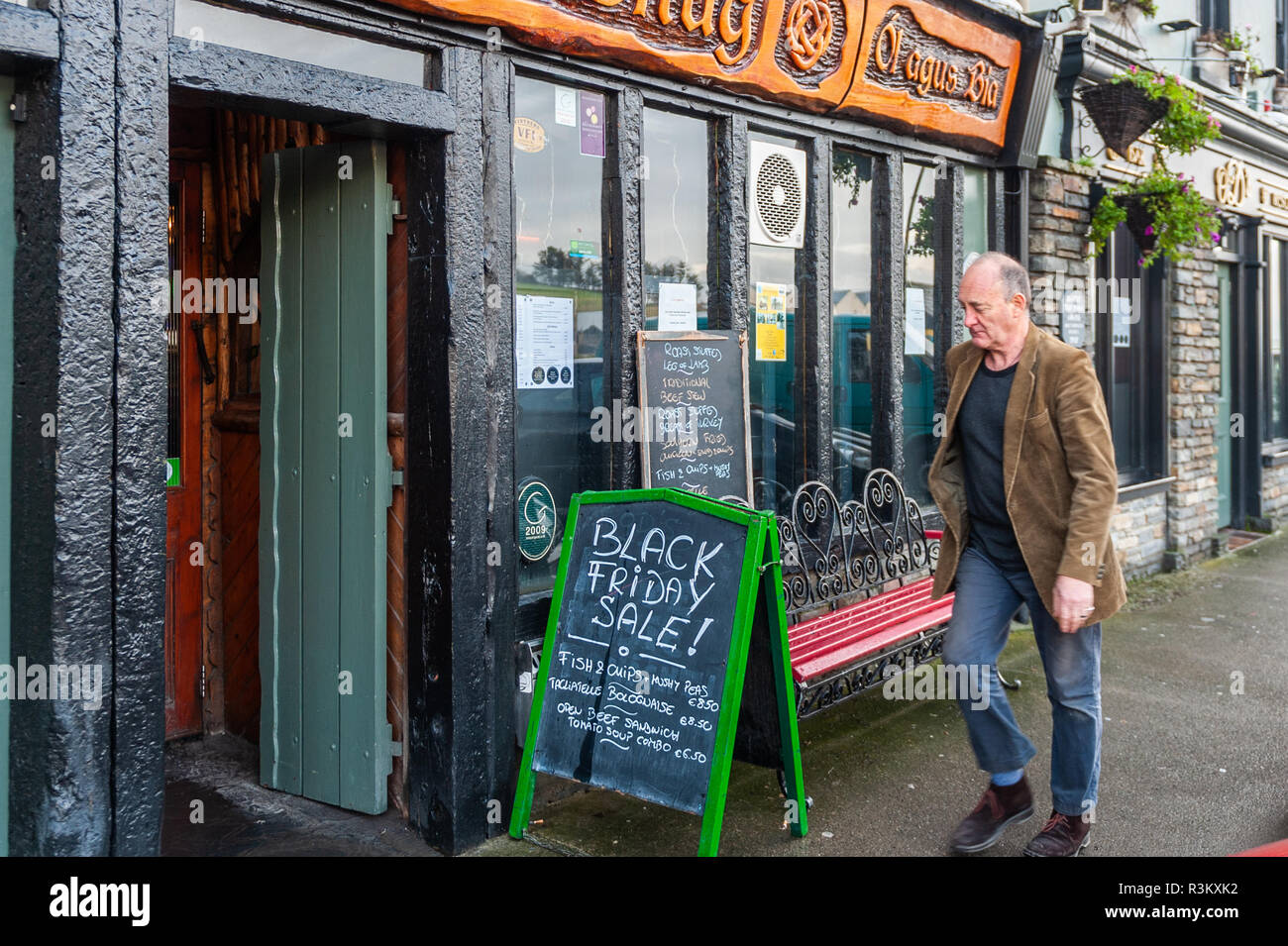 Bantry, West Cork, Ireland. 23rd Nov, 2018. A man approaches a restaurant advertising a Black Friday sale on a busy day in the West Cork town. Credit: Andy Gibson/Alamy Live News. Stock Photo