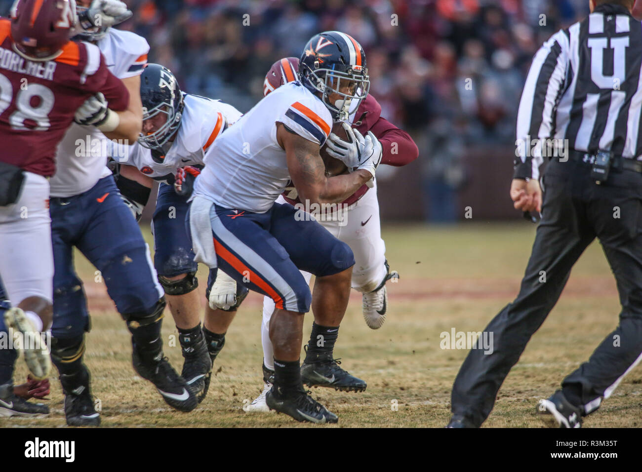 Blacksburg, VA, USA. 23rd Nov, 2018. Virginia Cavaliers running back Jordan Ellis (1) tries to break free of Hokie defenders during NCAA football action between the Virginia Cavaliers and the Virginia Tech Hokies at Lane Stadium in Blacksburg, VA. Jonathan Huff/CSM/Alamy Live News Stock Photo