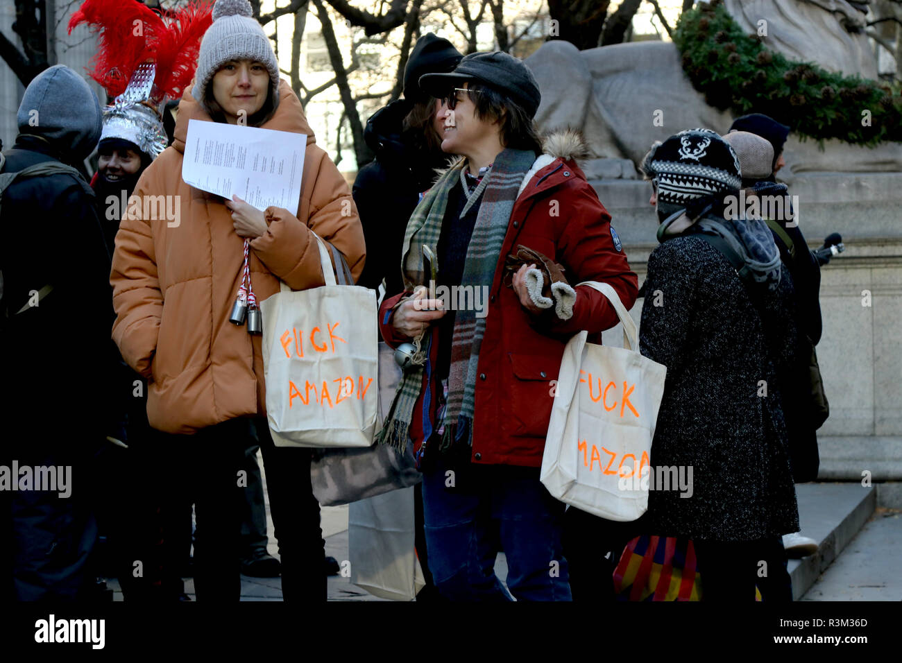 New York, NY, USA. 23 Nov., 2018. Continued opposition to online retailer Amazon second headquarters (HQ2) in Long Island City was staged on 23 November 2018, against the on-line retail giant forthcoming presence in New York City. Activists gathered at the NY public library in Manhattan and marched to the retailer bookstore in Herald Square, singing Christmas carols and handing out fliers. © 2018 G. Ronald Lopez/DigiPixsAgain.us/AlamyLive News Stock Photo