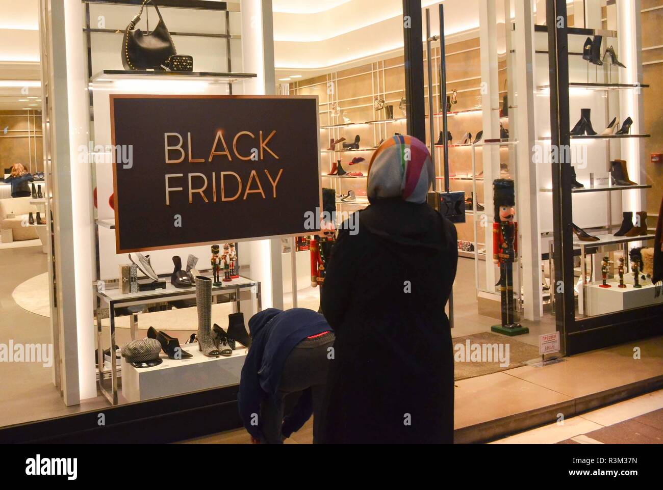 Athens, Greece. 23rd Nov, 2018. A woman seen looking at shoes displayed in  a store during the Black Friday.Black Friday kicked off early this morning  as retail shop started sales ranging from