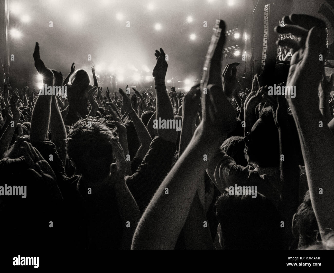 Crowd at a concert with clapping hands up Stock Photo - Alamy